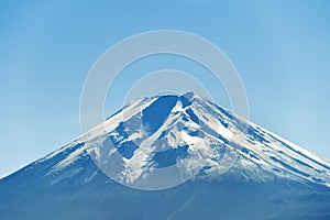 Close up of Fuji mountain peak with snow cover on the top with b