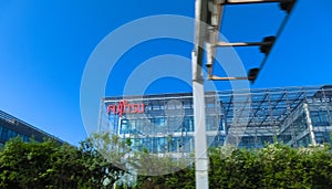 Close up of Fujitsu sign on their office building in Chech. Fujitsu is a Japanese information and communication