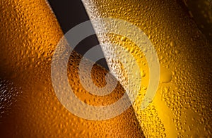 Close up of a full beer glass cold beer condensation with a defocused bottle detail