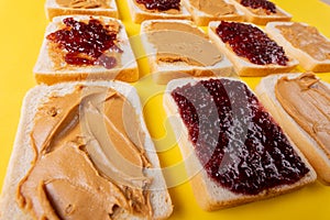 Close-up full frame shot of bread slices with preserves and peanut butter arranged alternatively