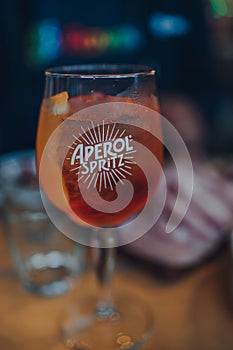 Close up of a full glass of Aperol Spritz cocktail,on an outdoor table of a restaurant