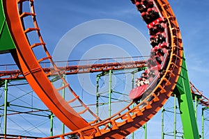 Close-up of a fun roller coaster ride. Blurred image of a train to convey movement in the frame