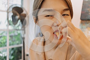 Close up of funny face woman eating french fries.