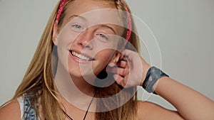 Close up of funny little girl with brown eyes and blonde hair laughing