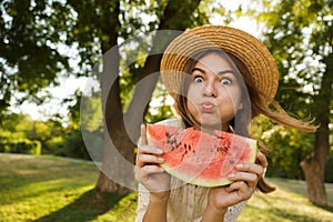 Close up of funny young girl in summer hat spending time at the park,