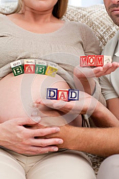 Close up of future parents holding cubes