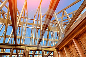 Close-up of gables roof on stick built home under construction and blue sky