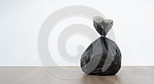 Close up garbage bag on wooden floor with white background