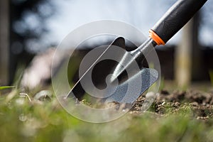 Close up of a garden shovel stabbed to soil; spring work