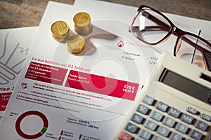 Close up of gas bill with calculator and stacked of coins