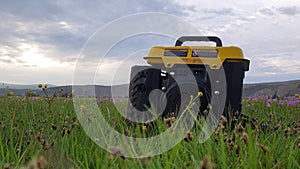 Close up of gas diesel mobile portable electricity generator work on grass. Gasoline fuel powered portable generator