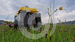 Close up of gas diesel mobile portable electricity generator work on grass. Gasoline fuel powered portable generator