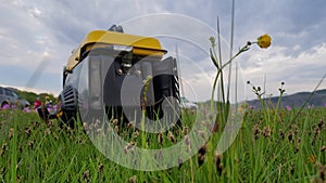 Close up of gas diesel mobile portable electricity generator work on grass. Gasoline fuel powered portable generator photo