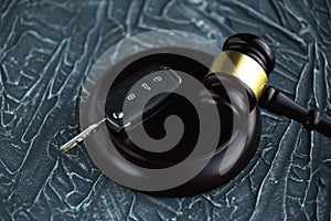 Close-up Of Gavel And Car Key On Sounding Block Against