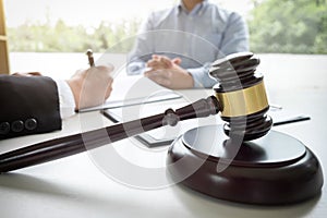 Close up of gavel, Male lawyer or judge Consult with client and
