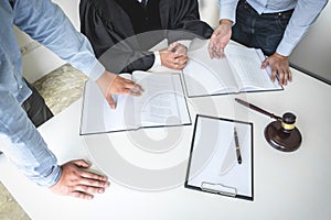 Close up of gavel, Male lawyer and older judge Consult with client on the case and working with Law books, report the case on tab