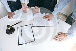 Close up of gavel, Male lawyer and older judge Consult with client on the case and working with Law books, report the case on tab