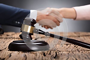 Close-up Of A Gavel On Wooden Desk