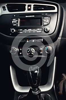 Gear shift in the car and central console in the background