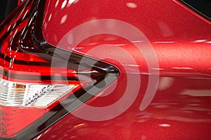 Close-up on generic rear light of a car on red