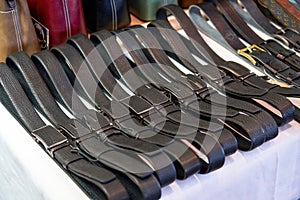 Close-up of genuine leather belts for sale in store