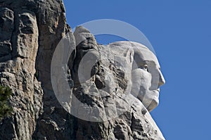 Close up of George Washington`s head on Mount Rushmore with blue sky