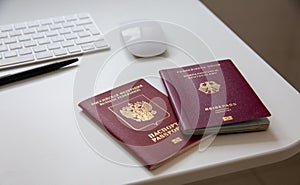 Close up of a German and a Russian passport on white table