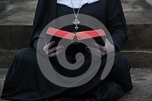 Close up of a ghost nun or demon in the mysterious holding the Bible.