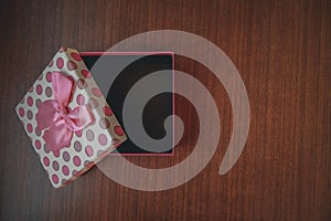 Close up of gift box on wooden background for special day