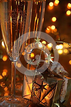 Close-up of gift and champagne in glasses.