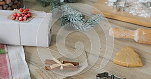 Close-up of gingerbread dough with flour and cookie cutter on table. Traditional homemade christmas dessert