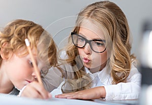 Close up of girl and boy writing