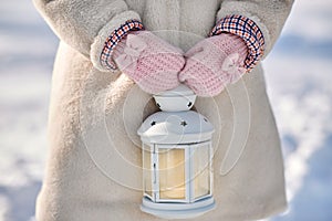 Close up of girl with christmas lantern in winter