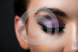 close up of girl with closed eye and glitter eyeshadows