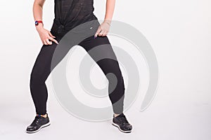 Close-up of girl dancing twerk in the dance class on white background