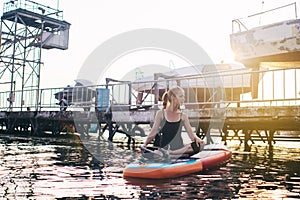 Close-up of a girl doing yoga on sub board. Psychology meditation, relaxation and self-healing concept. Lonely woman alone on