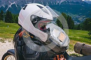 Close up of girl dressed in protective suit of body armor, tutle prtotective jacket, with helmet and glowes. Adventure motorcycle