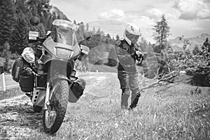 Close up of girl dressed in protective suit of body armor, tutle prtotective jacket, with helmet and glowes. Adventure motorcycle