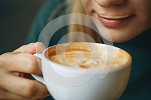 Close up girl is drinking coffee