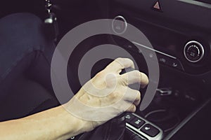 Close up of girl driving car moving transmission shift gear. Concept of female driving car. Using vehicle with modern automatic