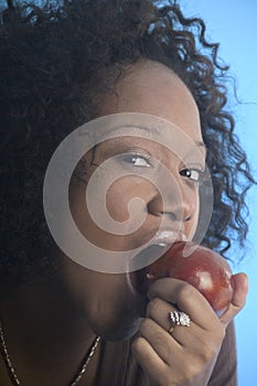 Close up of a girl eating an apple