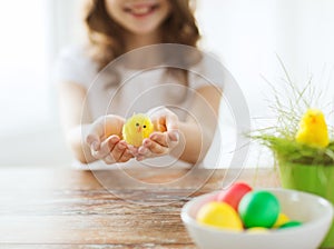 Close up of girl holding yellow chiken toy