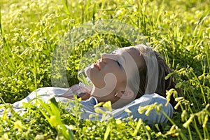 Close-up of a girl lying on the green grass