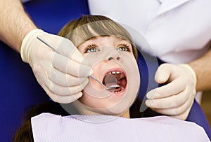 Close-up of girl opening his mouth wide during inspection