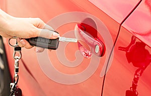 Close-up, girl opens the door car by key