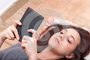 Close up of a girl reading an e-book