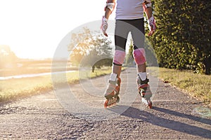 Close up of girl rollerblading in park. Outdoor, recreation, lifestyle, rollerblading.