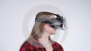 Close-up of the girl that rotates head in virtual reality helmet