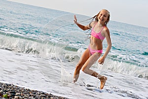 Close-up girl running on beach