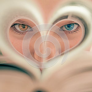 close-up girl's face with different eye colors, green and brown eyes. Heart-shaped eyes close-up,